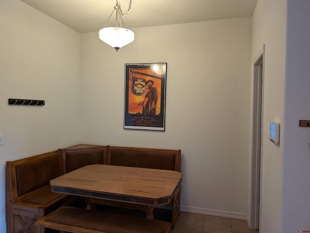 dining area featuring breakfast area and light tile patterned floors