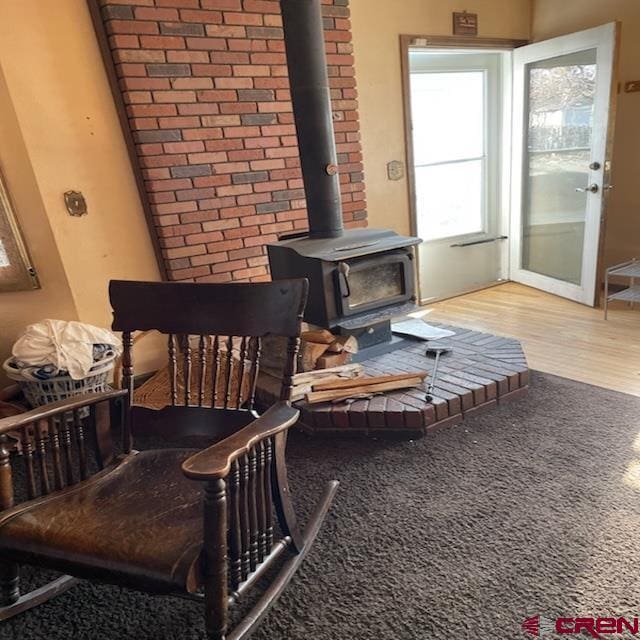 details with wood-type flooring and a wood stove