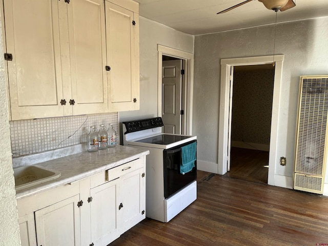 kitchen with white cabinetry, dark hardwood / wood-style flooring, and electric range