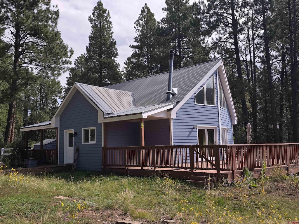 rear view of house featuring a deck