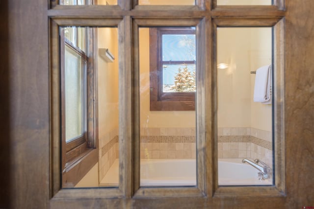 interior space with tiled bath