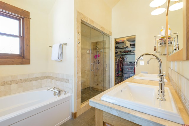 bathroom featuring shower with separate bathtub, tile patterned floors, and vanity