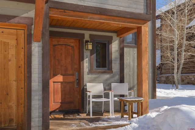 view of snow covered property entrance