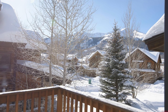 yard layered in snow with a mountain view