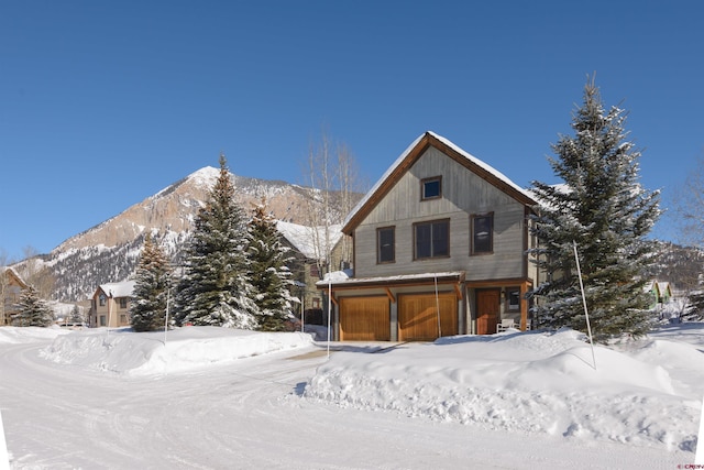 view of front of home featuring a garage and a mountain view