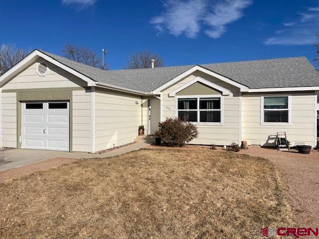 ranch-style house with a garage and a front yard