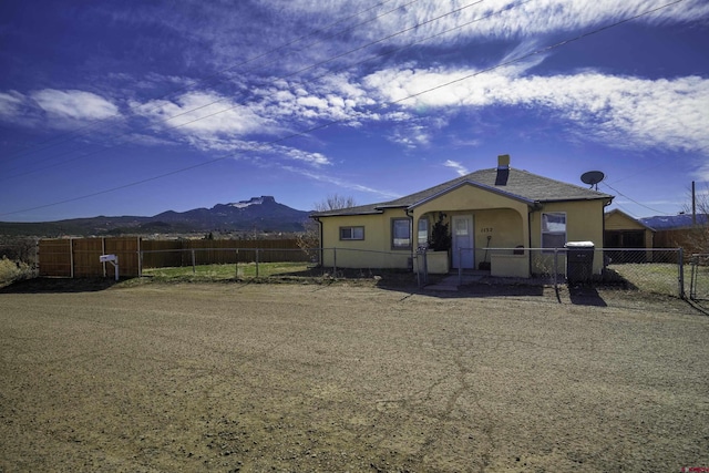 rear view of house featuring a mountain view