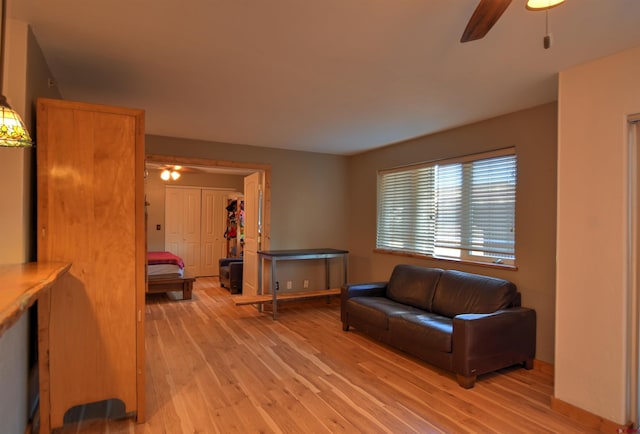 living room with ceiling fan and light hardwood / wood-style floors