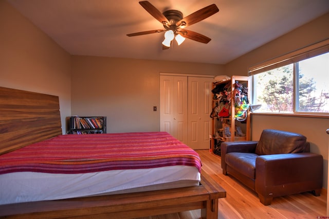 bedroom with ceiling fan, light hardwood / wood-style floors, and a closet