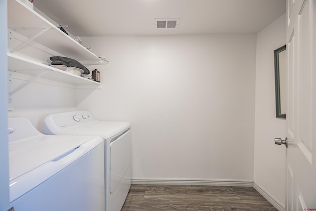 laundry room with dark hardwood / wood-style flooring and separate washer and dryer