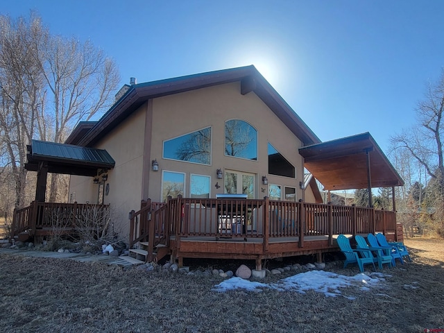 rear view of house featuring a deck