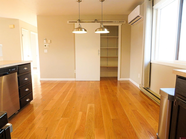 unfurnished dining area with light hardwood / wood-style flooring, an AC wall unit, and baseboard heating