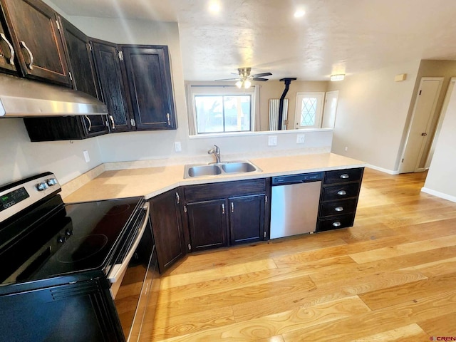 kitchen featuring appliances with stainless steel finishes, sink, ceiling fan, kitchen peninsula, and light hardwood / wood-style flooring