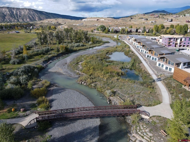 drone / aerial view featuring a water and mountain view