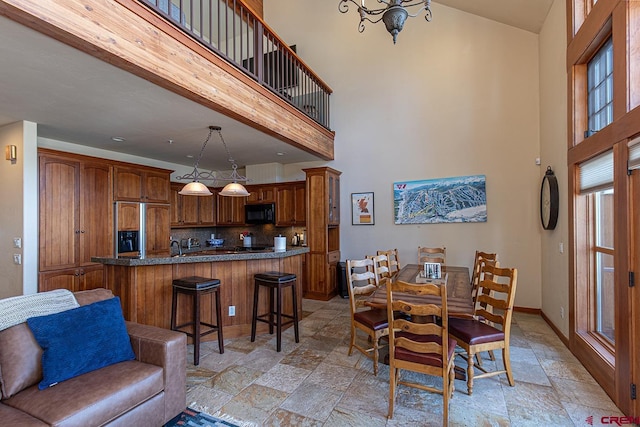 dining room featuring a towering ceiling