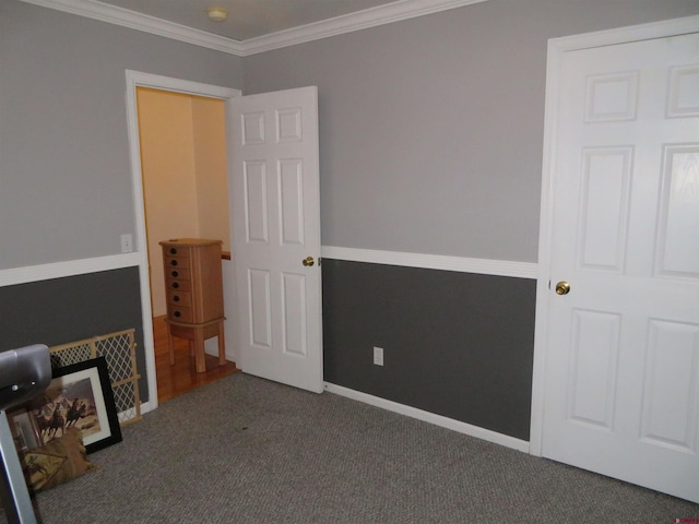 spare room with dark carpet and ornamental molding