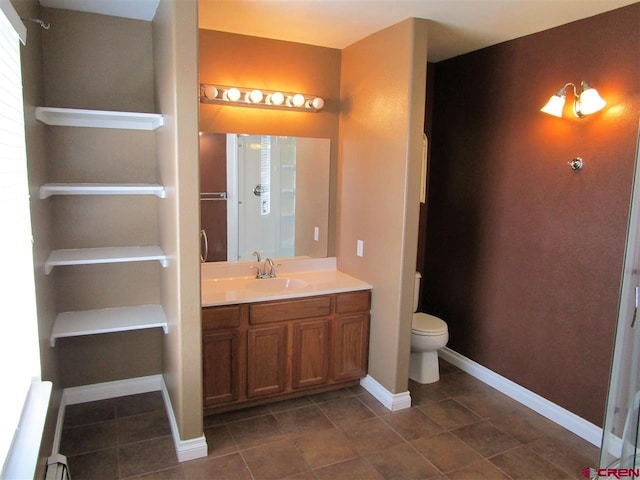 bathroom with a baseboard radiator, vanity, toilet, and tile patterned flooring