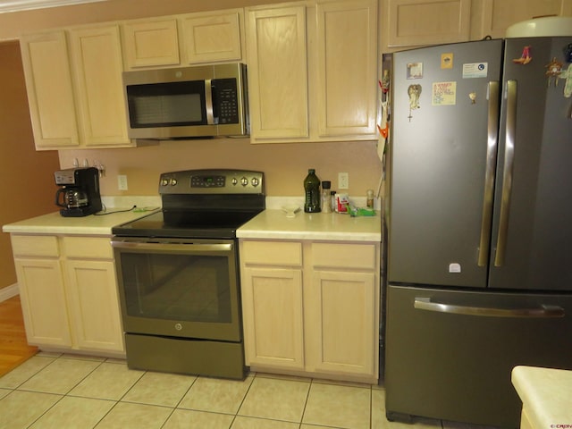 kitchen with appliances with stainless steel finishes and light tile patterned floors