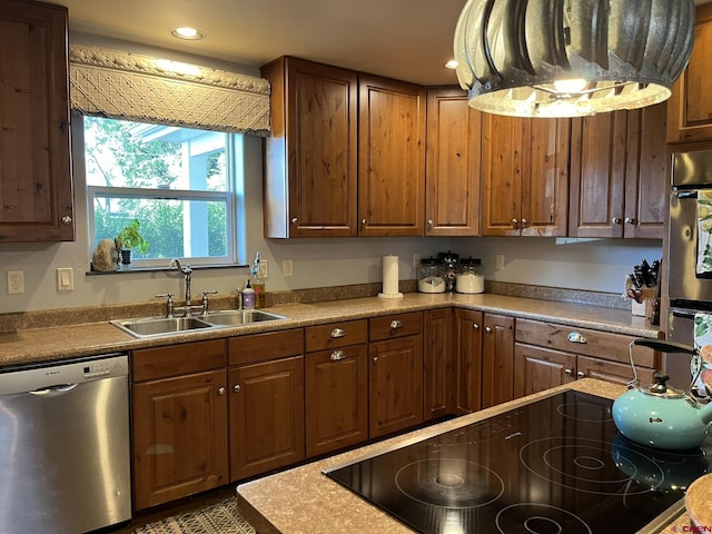 kitchen with sink, stainless steel dishwasher, and range