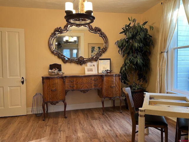 room details with hardwood / wood-style flooring and a notable chandelier