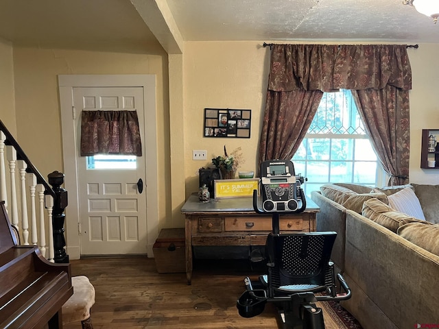 entryway with dark hardwood / wood-style flooring and a textured ceiling