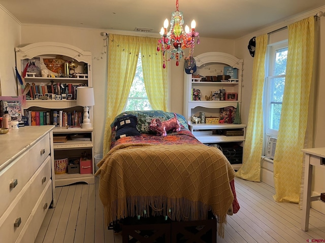 bedroom featuring crown molding, a notable chandelier, and light hardwood / wood-style floors