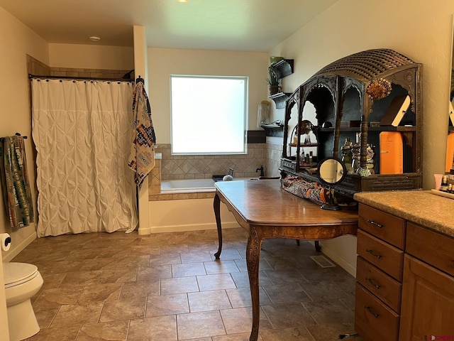 full bathroom featuring vanity, shower with separate bathtub, and toilet