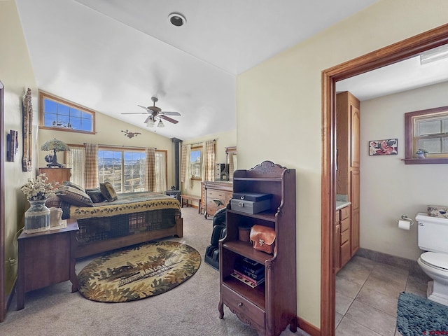 bedroom featuring ceiling fan, lofted ceiling, and light tile patterned floors