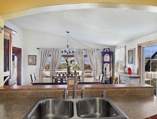 kitchen with decorative light fixtures, a chandelier, and sink