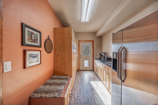 kitchen with stainless steel refrigerator with ice dispenser and dark hardwood / wood-style floors