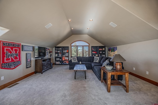 carpeted living room featuring vaulted ceiling