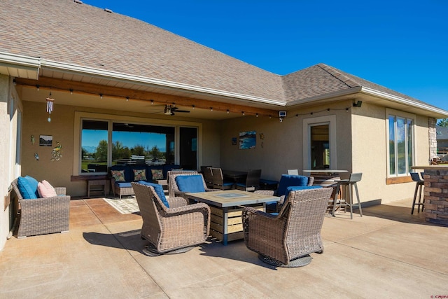 view of patio with an outdoor living space with a fire pit and ceiling fan