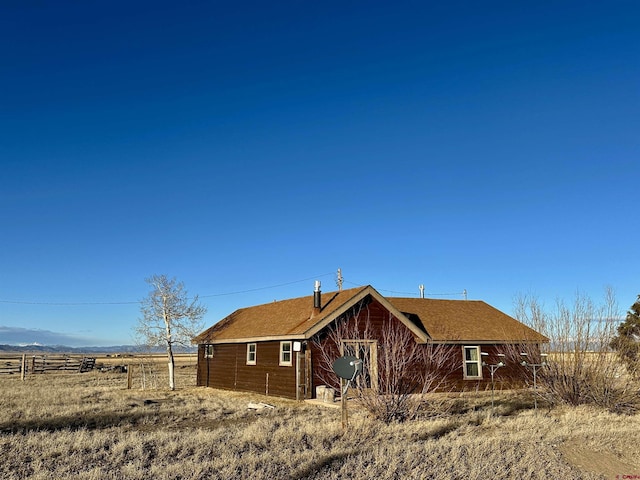 rear view of property with a rural view