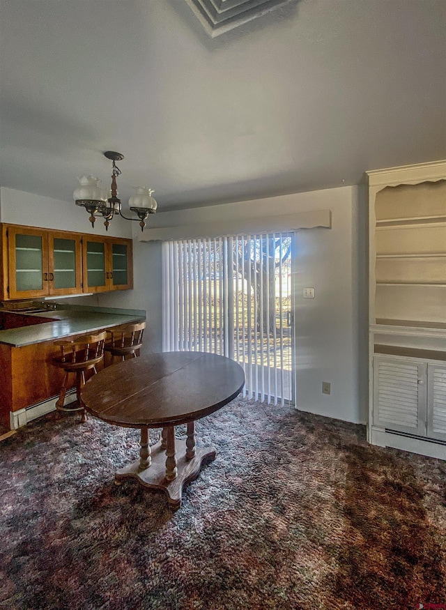 carpeted dining area with a baseboard radiator and a chandelier