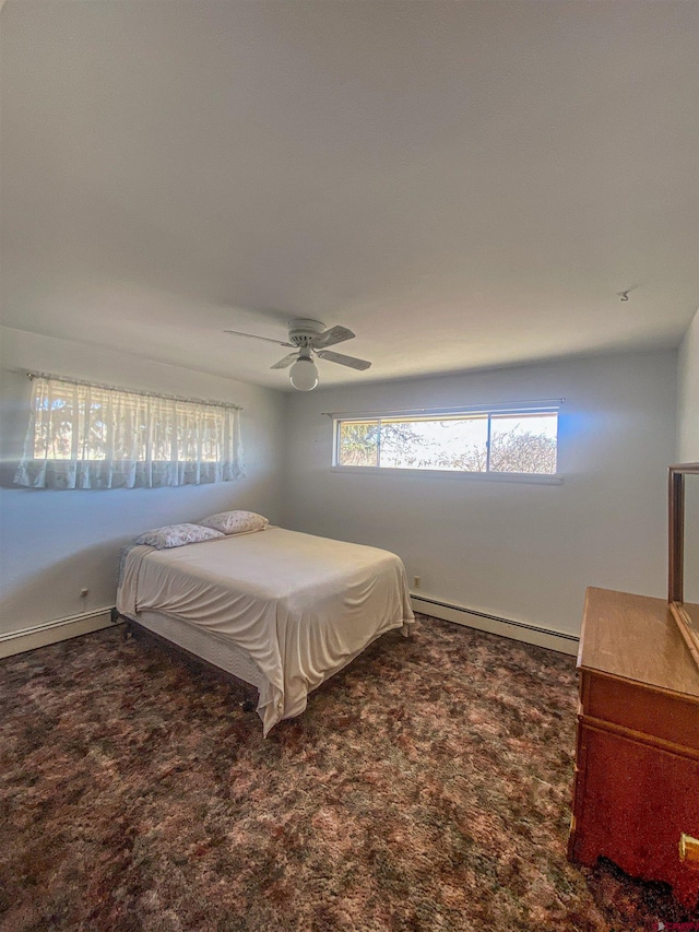 carpeted bedroom with a baseboard radiator and ceiling fan