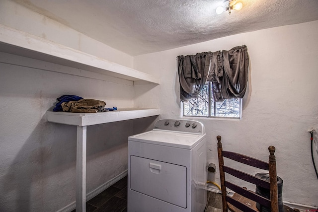 laundry area featuring washer / clothes dryer and a textured ceiling