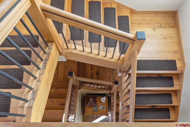 stairs featuring wooden walls