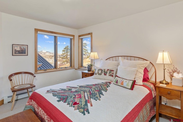 bedroom featuring a baseboard heating unit and carpet