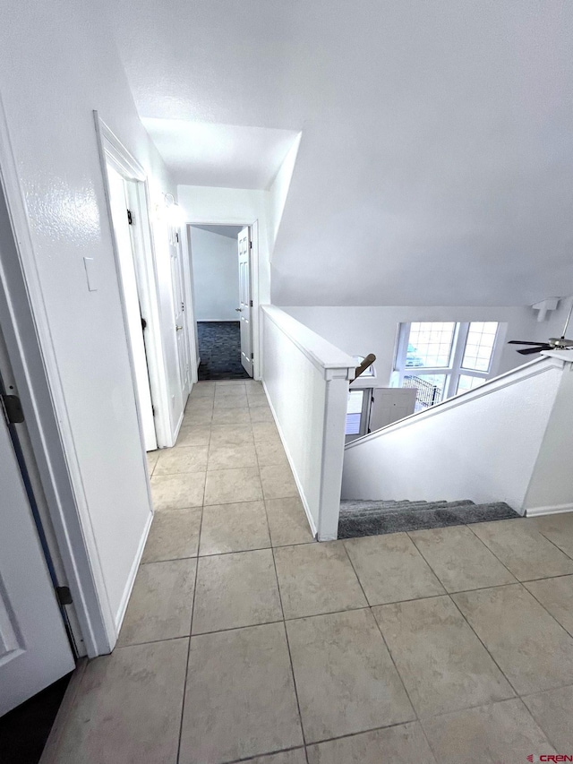 hall with light tile patterned floors