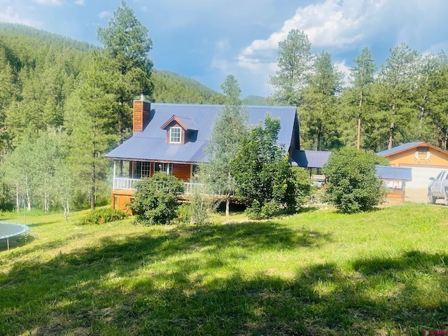 rear view of house featuring a yard