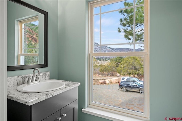 bathroom featuring vanity, a mountain view, and plenty of natural light