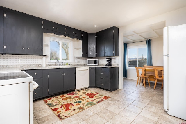 kitchen featuring tasteful backsplash, light tile patterned flooring, sink, and white appliances