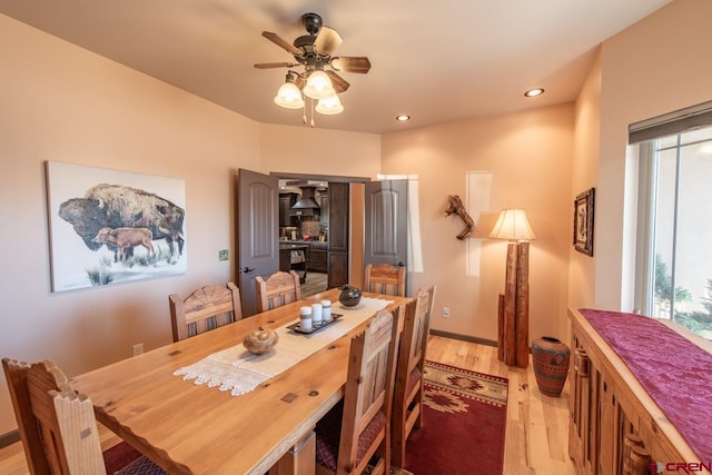 dining space featuring ceiling fan and light hardwood / wood-style flooring