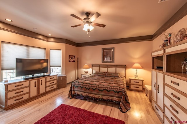 bedroom with crown molding and light hardwood / wood-style flooring