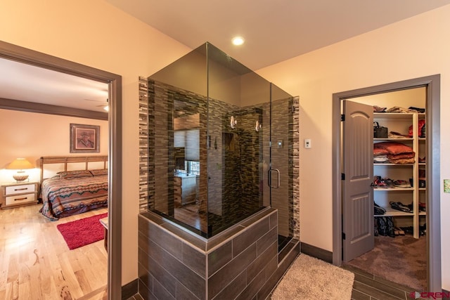 bathroom featuring an enclosed shower and hardwood / wood-style flooring