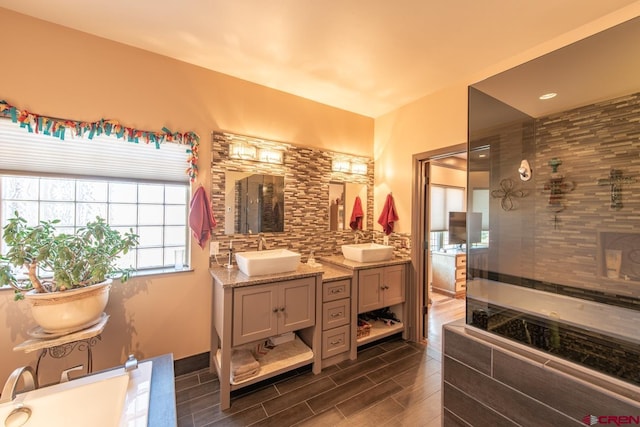 bathroom with vanity, backsplash, and walk in shower