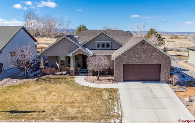 view of front of house featuring a garage, a front lawn, and a porch