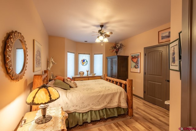 bedroom with ceiling fan and light hardwood / wood-style floors