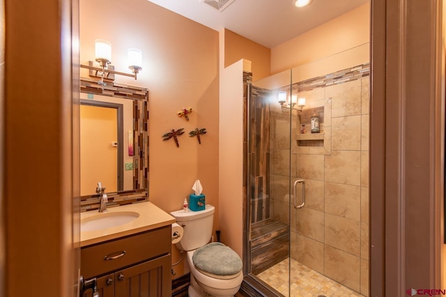 bathroom with vanity, toilet, and walk in shower