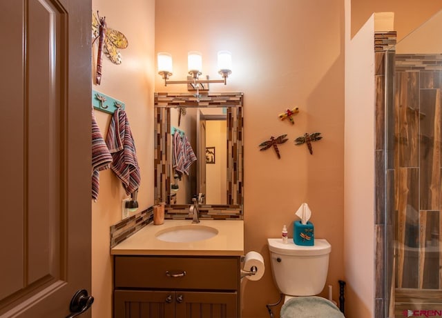 bathroom featuring vanity, a shower, and toilet